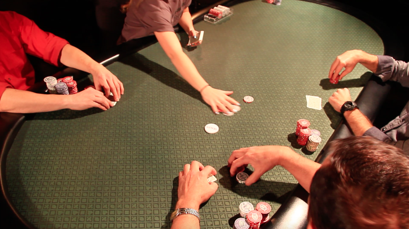 Poker table, dealer pulling in chips