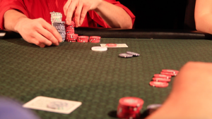 Poker table, player grabbing chips