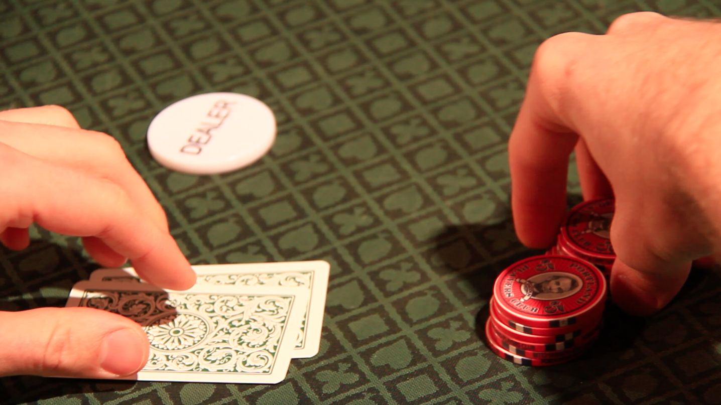 Poker chips, player grabbing chips, ready to bet